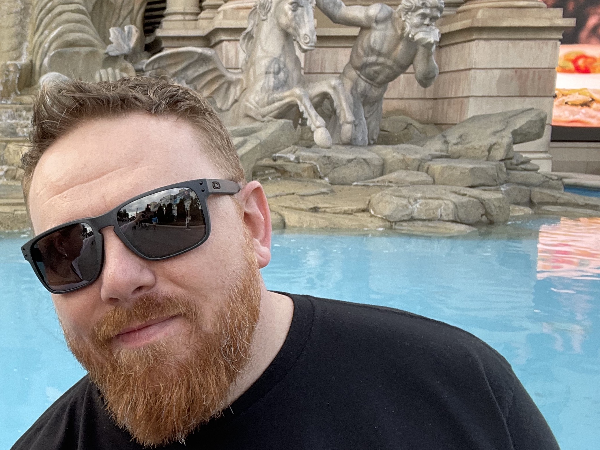 Selfie in sunglasses in front of a fountain with marble horse statues in Las Vegas